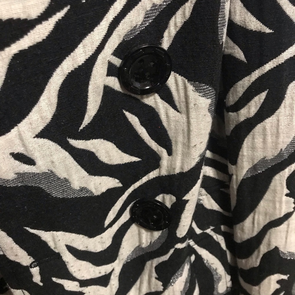 Zebra print jacket with pink inside.